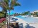 Resort-style swimming pool with blue umbrellas and lounge chairs for relaxing by the water at 8013 Cool Breeze Dr # 116, Orlando, FL 32819