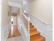 Elegant staircase with white railings and hardwood floors at 8013 Cool Breeze Dr # 116, Orlando, FL 32819