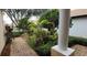 Inviting walkway leads to the front door, surrounded by lush landscaping and a charming column accent at 8327 Via Verona, Orlando, FL 32836