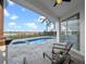 Outdoor patio with a pool, palm trees, and blue skies enhance this backyard retreat at 8519 Saint Marino Blvd, Orlando, FL 32836