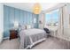 Charming bedroom with a wood accent wall, desk, and pendant light, offering a cozy and stylish retreat at 10231 Beechwood Ln, Orlando, FL 32832