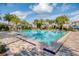 Large community swimming pool surrounded by palm trees and lounge chairs at 10231 Beechwood Ln, Orlando, FL 32832