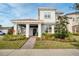 Charming two-story home with a tile roof, landscaped yard, and covered front porch at 10231 Beechwood Ln, Orlando, FL 32832