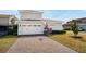 Home exterior showing garage, basketball hoop and brick paver driveway at 10231 Beechwood Ln, Orlando, FL 32832