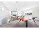 Bright game room featuring a ping pong table, carpet flooring, and a projector screen for entertainment at 10231 Beechwood Ln, Orlando, FL 32832