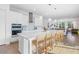 Bright, open kitchen features a large island, stainless appliances, and pendant lighting at 10231 Beechwood Ln, Orlando, FL 32832