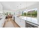 Modern open concept kitchen, large quartz island with seating, and stainless appliances at 10231 Beechwood Ln, Orlando, FL 32832
