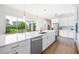 Modern open concept kitchen with oversized island with seating, stainless appliances, and backyard views at 10231 Beechwood Ln, Orlando, FL 32832
