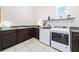 Well-equipped laundry room with granite counters, modern washer and dryer at 10231 Beechwood Ln, Orlando, FL 32832