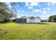 Expansive backyard featuring a screened-in patio and lush green grass at 10305 Licorice Way, Orlando, FL 32821
