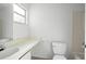 Bright bathroom featuring a clean white sink, toilet, and a well-lit window at 10305 Licorice Way, Orlando, FL 32821