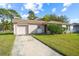 Inviting one-story house featuring an attached garage and a neatly manicured front yard at 10305 Licorice Way, Orlando, FL 32821