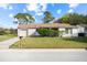Charming single-story home with a well-maintained lawn and a driveway leading to an attached garage at 10305 Licorice Way, Orlando, FL 32821