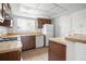 Functional kitchen with wooden cabinetry, essential appliances, and ample counter space at 10305 Licorice Way, Orlando, FL 32821