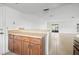 Kitchen featuring wood cabinets, a pass-through bar, tile floor, and an opening into the living area at 10305 Licorice Way, Orlando, FL 32821