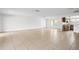 Bright living room with tile floors flowing into the kitchen, featuring natural light from a nearby window at 10305 Licorice Way, Orlando, FL 32821