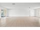 Spacious, sunlit living room with tiled floors and sliding glass doors that lead to the backyard at 10305 Licorice Way, Orlando, FL 32821