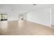 Bright and airy living room featuring tile flooring and sliding glass doors leading to an enclosed patio at 10305 Licorice Way, Orlando, FL 32821