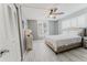 Bright bedroom featuring wood-look tile floors, ceiling fan, and plantation shutters at 111 S Atlantic Ave # 301, Ormond Beach, FL 32176