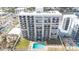 Modern condo building featuring private balconies, a refreshing pool, and inviting outdoor lounge areas for relaxation at 111 S Atlantic Ave # 301, Ormond Beach, FL 32176