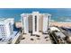 Exterior view of high-rise condo building near the beach with well-maintained parking and ocean views at 111 S Atlantic Ave # 301, Ormond Beach, FL 32176