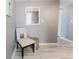 Hallway with modern furnishings, a white accent chair, a mirror, and light gray paint at 111 S Atlantic Ave # 301, Ormond Beach, FL 32176
