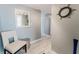 Hallway with modern furnishings, a white accent chair, a mirror, and light gray paint at 111 S Atlantic Ave # 301, Ormond Beach, FL 32176