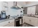 A modern kitchen features stainless steel appliances, granite countertops, and white cabinetry at 111 S Atlantic Ave # 301, Ormond Beach, FL 32176