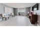 Spacious living room with wood-look tile floors and a sliding glass door leading to a balcony at 111 S Atlantic Ave # 301, Ormond Beach, FL 32176
