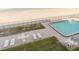 Birds eye view of the community pool, brick patio and beach at 111 S Atlantic Ave # 301, Ormond Beach, FL 32176