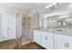 Modern bathroom featuring a walk-in shower, double sink vanity, and ample lighting at 1161 Spinning Wheel Dr, Apopka, FL 32712