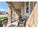 Charming front porch featuring stone columns, hanging porch swing, and a welcoming bench with decorative pillows at 1161 Spinning Wheel Dr, Apopka, FL 32712