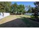 Expansive backyard featuring lush green grass, mature trees, and a white vinyl fence for privacy at 1217 E Muriel St, Orlando, FL 32806