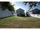 The spacious backyard includes a white fence, lush green grass, and healthy landscaping at 1217 E Muriel St, Orlando, FL 32806