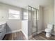 Bathroom featuring a step-in shower with glass doors and a window for natural light at 1217 E Muriel St, Orlando, FL 32806