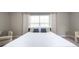 Bright bedroom featuring a comfortable bed with blue accents, natural light, and cozy seating at 1217 E Muriel St, Orlando, FL 32806