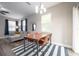 Open concept dining area featuring a ceiling fan, hardwood floors, and modern furniture at 1217 E Muriel St, Orlando, FL 32806