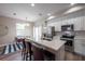 An open concept kitchen with stainless appliances, island with breakfast bar, and dining area at 1217 E Muriel St, Orlando, FL 32806
