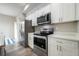 Modern kitchen with stainless steel appliances, white cabinetry and stone countertops at 1217 E Muriel St, Orlando, FL 32806