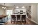 Open concept kitchen with white cabinetry, stainless appliances, island, and adjacent dining area at 1217 E Muriel St, Orlando, FL 32806