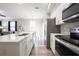 Modern kitchen with stainless steel appliances, white countertops, and hardwood floors at 1217 E Muriel St, Orlando, FL 32806
