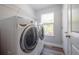 Laundry room features a newer washer and dryer and shelving at 1217 E Muriel St, Orlando, FL 32806