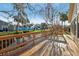 Backyard deck overlooking a small creek, lush trees, and neighboring properties at 124 Loon Ct, Daytona Beach, FL 32119