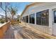 An exterior deck with adjacent sunroom with large picture windows overlooking the backyard at 124 Loon Ct, Daytona Beach, FL 32119