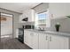 Modern kitchen with white cabinets, gray countertops and island at 1356 Cupid Ave, Christmas, FL 32709