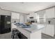 Spacious kitchen with white cabinets, an island, and stainless steel appliances at 1356 Cupid Ave, Christmas, FL 32709