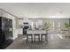 Modern kitchen features island with seating, white cabinets, and stainless steel appliances at 1356 Cupid Ave, Christmas, FL 32709