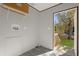 Laundry room features a door to backyard and built in shelving at 1356 Cupid Ave, Christmas, FL 32709