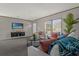 Cozy living room includes comfortable seating, a large TV, and a coffee table at 1356 Cupid Ave, Christmas, FL 32709