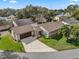 Aerial view of home with lush landscaping, a well-manicured lawn, and a large driveway at 1417 Borg Ln, Winter Springs, FL 32708